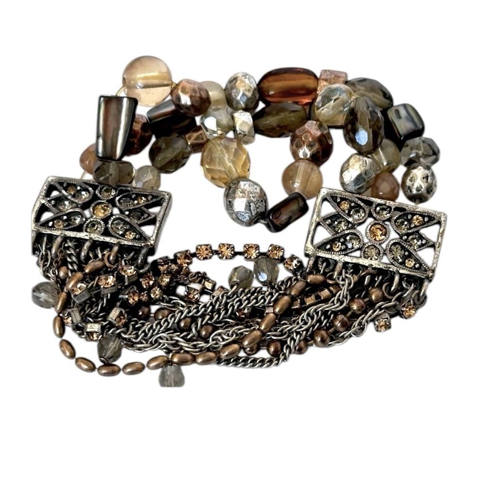 Multi-strand chains, rhinestones, brown and neutral-toned beads bracelet.